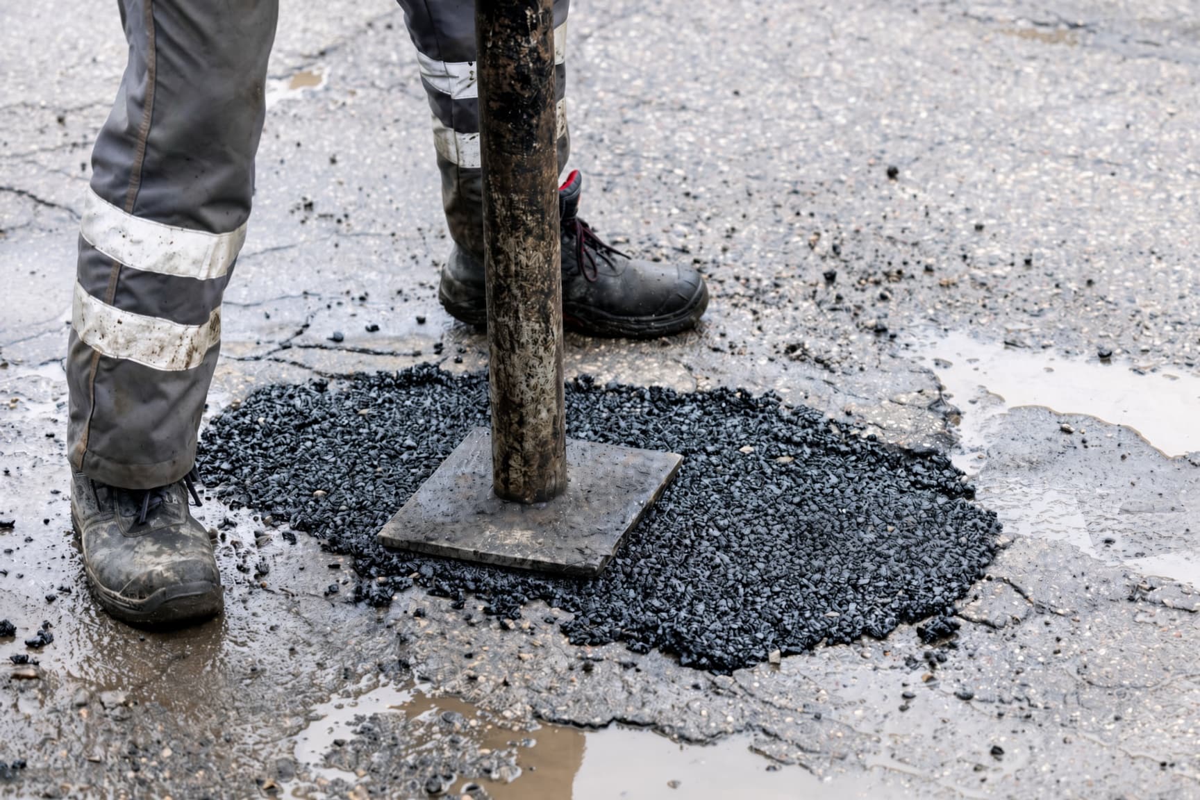 Full-depth hot mix pothole repair on a Plano driveway