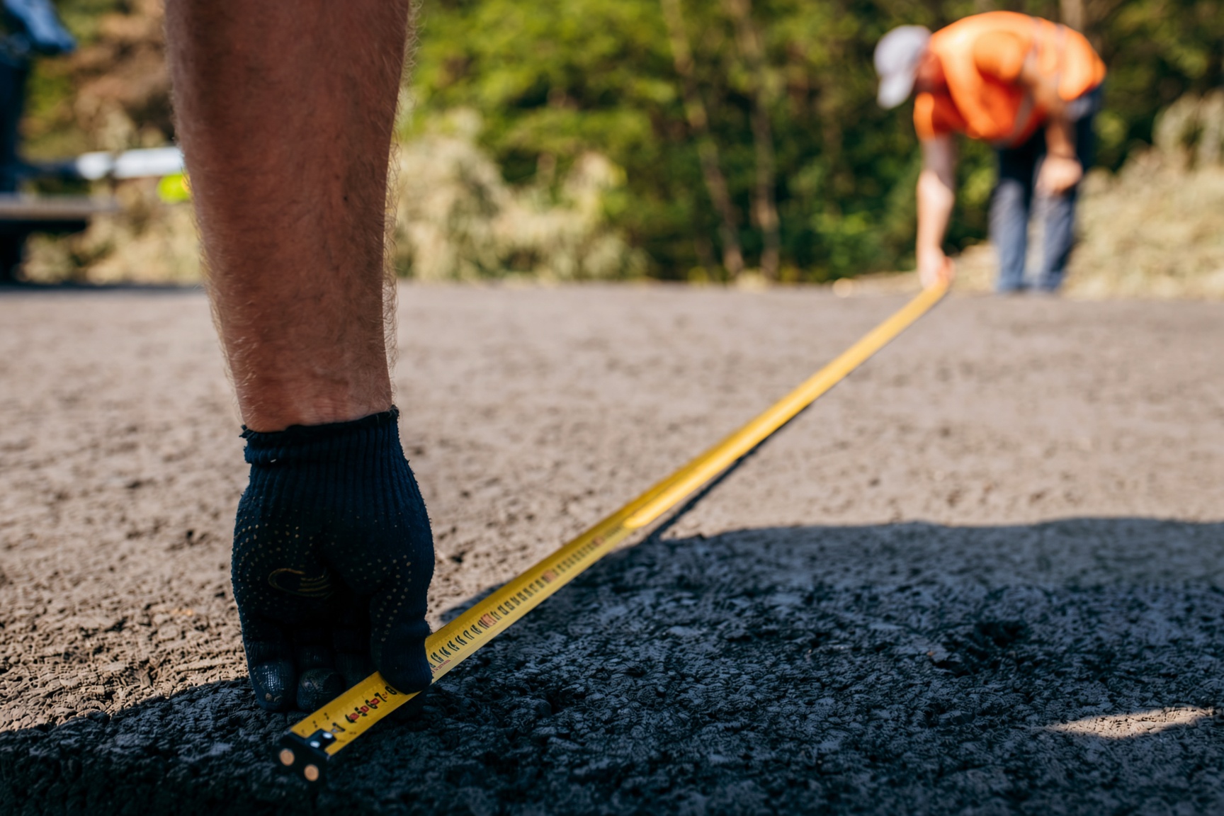 Estimator measuring a commercial parking lot for paving in Plano TX