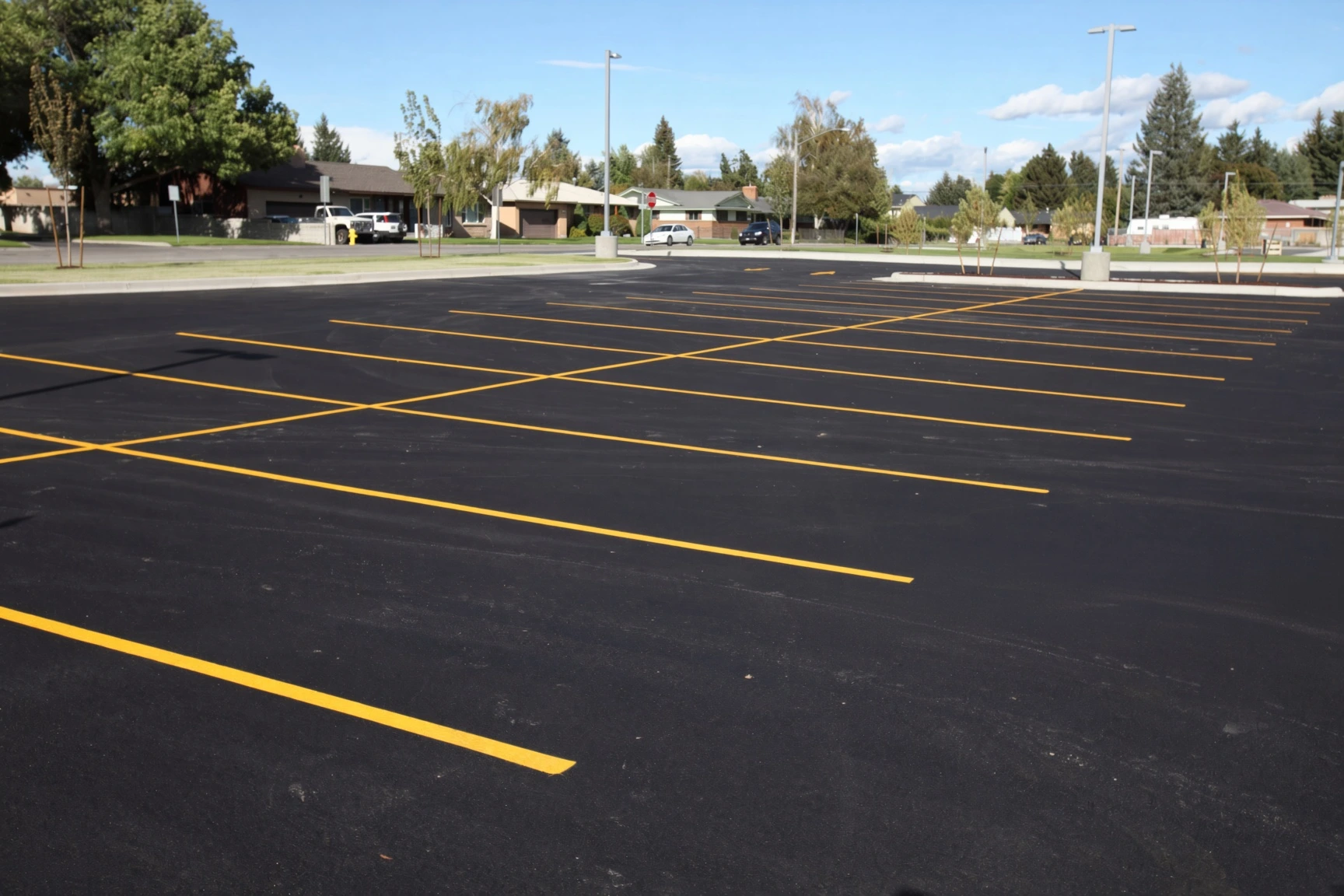 Commercial sealcoating being applied to a Plano parking lot